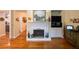 Cozy living room features a fireplace, built-in shelving, and beautiful hardwood floors at 3833 Savannah E Sq, Atlanta, GA 30340