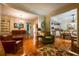 Spacious living room with hardwood floors, fireplace, and a large window letting in natural light at 3833 Savannah E Sq, Atlanta, GA 30340