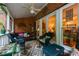 Cozy covered patio featuring brick accent wall, comfortable seating, and decorative rug at 3833 Savannah E Sq, Atlanta, GA 30340