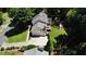 Aerial view of a well-maintained home, with a leafy green yard, mature trees, and a three car garage at 3837 Fenway Xing, Marietta, GA 30062