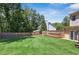 Expansive backyard features a lush lawn, wooden fence, and ample space for outdoor activities and entertaining at 3837 Fenway Xing, Marietta, GA 30062