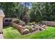 Backyard featuring lush landscaping, a retaining wall, and stone steps, creating a tranquil outdoor space at 3837 Fenway Xing, Marietta, GA 30062