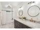 This bathroom features a double vanity, marble countertop, updated light fixtures, and tub with shower at 3837 Fenway Xing, Marietta, GA 30062
