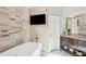 Bathroom featuring a soaking tub, stylish vanity, and modern finishes at 3837 Fenway Xing, Marietta, GA 30062
