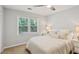 This bedroom includes a fan, window with blinds, neutral walls, and carpeted floor at 3837 Fenway Xing, Marietta, GA 30062