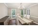 Formal dining room with modern chandelier, table, and sideboard at 3837 Fenway Xing, Marietta, GA 30062