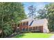 Charming two-story brick home with black shutters, manicured lawn, and mature trees adding curb appeal at 3837 Fenway Xing, Marietta, GA 30062
