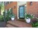 Inviting front entrance with potted hydrangeas on a brick porch and a screen door at 3837 Fenway Xing, Marietta, GA 30062