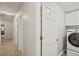 Hallway showing laundry closet with washer and dryer, white paint, carpet, and doors at 3837 Fenway Xing, Marietta, GA 30062