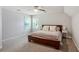 This bedroom features neutral walls, carpet, a ceiling fan, and multiple windows at 3837 Fenway Xing, Marietta, GA 30062