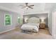Primary bedroom with tray ceilings, ceiling fan, and natural light at 3837 Fenway Xing, Marietta, GA 30062