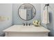 Chic powder room with a white marble countertop, round mirror, and bronze faucet at 3837 Fenway Xing, Marietta, GA 30062