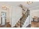 Elegant staircase with hardwood floors and wrought iron spindles at 3837 Fenway Xing, Marietta, GA 30062