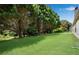 Backyard featuring well-manicured lawn with large trees offering shade and tranquility at 424 Yellow River Walk, Lawrenceville, GA 30043