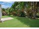 The backyard features a lush lawn with mature trees and a concrete patio at 424 Yellow River Walk, Lawrenceville, GA 30043