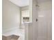 Bright bathroom features a shower and separate tub beneath a window for plenty of natural light at 424 Yellow River Walk, Lawrenceville, GA 30043