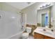 Well-lit bathroom featuring a sink, toilet and bath with shower at 424 Yellow River Walk, Lawrenceville, GA 30043
