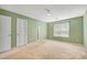 Green bedroom with two white doors and a window at 424 Yellow River Walk, Lawrenceville, GA 30043