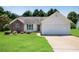 Charming single-story home with a brick accent, manicured lawn, and attached two-car garage at 424 Yellow River Walk, Lawrenceville, GA 30043