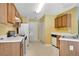 Functional kitchen with white appliances, ample cabinet space, and neutral countertops at 424 Yellow River Walk, Lawrenceville, GA 30043