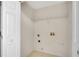 Small laundry room features a utility sink, shelving, and connections at 424 Yellow River Walk, Lawrenceville, GA 30043
