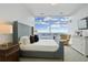 Bright bedroom featuring large windows, city views, and elegant gray upholstered bed frame at 45 Ivan Allen Jr Blvd # 2203, Atlanta, GA 30308