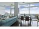 Living and dining area featuring hardwood floors, comfortable seating, and floor-to-ceiling windows at 45 Ivan Allen Jr Blvd # 2203, Atlanta, GA 30308