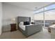 Inviting primary bedroom with a neutral color palette, carpet, and large windows boasting city views at 45 Ivan Allen Jr Blvd # 2203, Atlanta, GA 30308