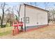Exterior elevation of home showing siding, red wooden deck and stairs at 4041 Blanton Sw Ave, Atlanta, GA 30331
