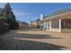 A large backyard with a view of the house, screened porch, wooden fence and other neighborhood homes at 5030 Mundy Dr, Cumming, GA 30028