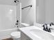 A clean, white bathroom with updated fixtures including a showerhead and towel bar at 5030 Mundy Dr, Cumming, GA 30028