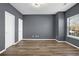 An empty bedroom with wood floors, light gray walls, and natural light from the window at 5030 Mundy Dr, Cumming, GA 30028