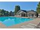 Inviting community pool with ample lounge chairs and a clubhouse, ideal for relaxing and socializing in a resort-like setting at 5030 Mundy Dr, Cumming, GA 30028