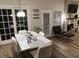 Dining room featuring a modern table set with hardwood floors and access to a living space at 5030 Mundy Dr, Cumming, GA 30028