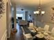 Open-concept dining room featuring a decorative chandelier and modern finishes at 5030 Mundy Dr, Cumming, GA 30028