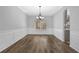 Bright dining room with new floors, wainscoting, and chandelier lighting at 5030 Mundy Dr, Cumming, GA 30028