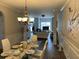Dining room with glass table and chandelier in an open-concept space at 5030 Mundy Dr, Cumming, GA 30028
