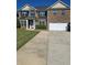 Two story brick home featuring a well manicured front yard and attached two car garage at 5030 Mundy Dr, Cumming, GA 30028