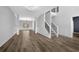 Open foyer featuring hardwood floors, a staircase with metal balusters, and ample natural light at 5030 Mundy Dr, Cumming, GA 30028