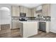 Bright kitchen featuring granite countertops, stainless steel appliances, and an eat-in island at 5030 Mundy Dr, Cumming, GA 30028