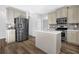 Modern kitchen with stainless steel appliances, island, and ample cabinet space at 5030 Mundy Dr, Cumming, GA 30028