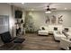 Cozy living room featuring a stone fireplace, hardwood floors, and comfortable seating at 5030 Mundy Dr, Cumming, GA 30028