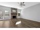 Bright living room with stone fireplace, hardwood floors, and sliding doors to the outdoor space at 5030 Mundy Dr, Cumming, GA 30028