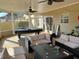 Relaxing screened-in patio featuring comfortable seating, a ceiling fan, and a billiards table for the ultimate outdoor experience at 5030 Mundy Dr, Cumming, GA 30028