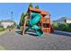 Fun community playground with a winding green slide and wooden play structure, perfect for outdoor adventures at 5030 Mundy Dr, Cumming, GA 30028