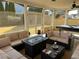 A well-appointed screened-in porch features a pool table, ceiling fan, and comfortable seating at 5030 Mundy Dr, Cumming, GA 30028