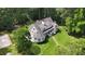 Home with a large backyard and sunroom addition, surrounded by mature trees and lush landscaping for privacy at 625 W Lake Dr, Oxford, GA 30054