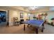 Spacious basement area perfect for recreation, featuring a ping pong table and ample storage space at 625 W Lake Dr, Oxford, GA 30054
