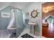 Bathroom with a vintage style, white fixtures, stained glass, and view to another bedroom at 625 W Lake Dr, Oxford, GA 30054