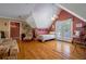 Bedroom with a pitched roof, ceiling fan, hardwood floors and french doors leading to a balcony at 625 W Lake Dr, Oxford, GA 30054